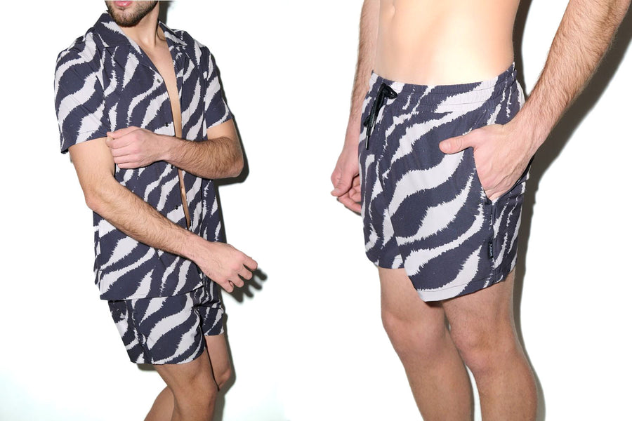 Model wearing PLAYALUXE men's swim trunks and cabana set