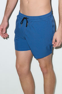 Men's petrol blue swim trunks with elastic waistband and black drawstring